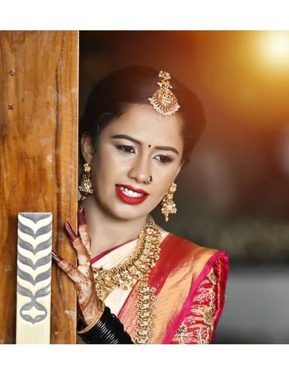 A lovely, soft-focus shot that captures a quiet moment. The makeup enhances her features beautifully, creating a very gentle and feminine look.