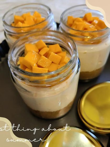 Our seasonal summer special, Mango Cheesecake served in individual jars. It features a biscuit base, creamy cheesecake filling, and is topped with fresh mango chunks.