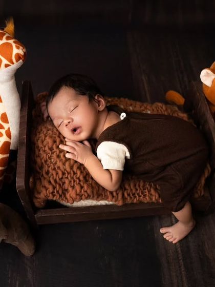 Surrounded by his favorite stuffed animal friends, this little one is sleeping peacefully. I use soft toys to add a touch of whimsy to my newborn photography.