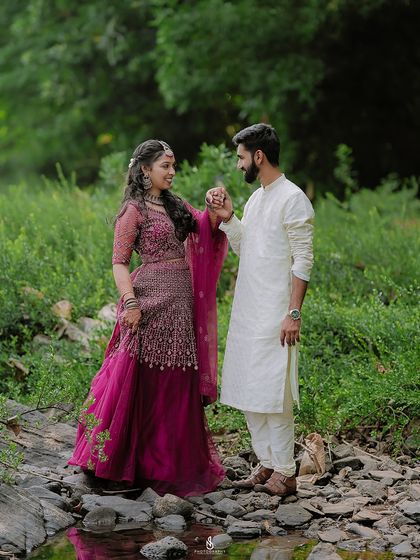 Holding hands amidst the greenery. This classic pose is timeless and always beautifully captures a couple's bond.