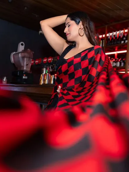 A creative shot for an ethnic wear brand, capturing a model in a modern checkered saree at a bar. I used a unique foreground blur to create depth and a cinematic feel for this lifestyle fashion photo.