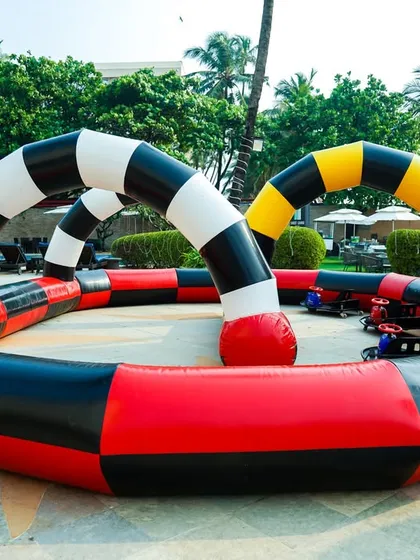 A go-karting experience with an inflatable track, providing a safe and defined racing circuit for young drivers.