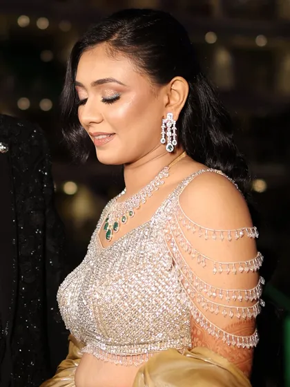 A close-up shot focusing on the details of the makeup and the intricate embroidery of her outfit.