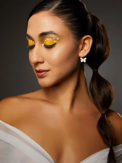 A sunny yellow eyeshadow look with delicate glitter, paired with a bubble ponytail, from our high-floral shoot.