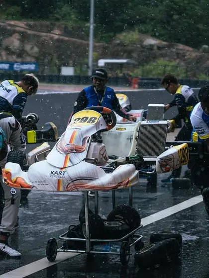 Our team rushes to make a setup change as the rain comes down, showcasing our ability to adapt to changing conditions.