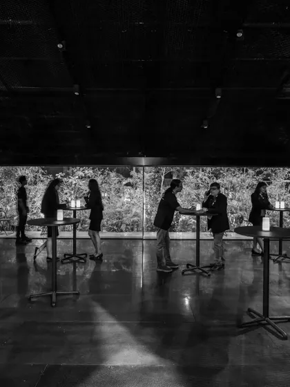 Another view of the pavilion in black and white, capturing the quiet interactions of visitors within the space. All architecture, permanent or temporary, must allow for moments of pause.