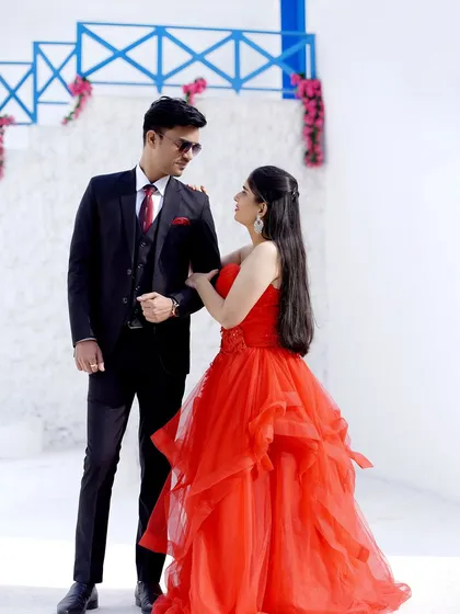 A stylish and confident pose from a pre-wedding shoot. The couple's coordinated outfits and strong presence make for a powerful image.