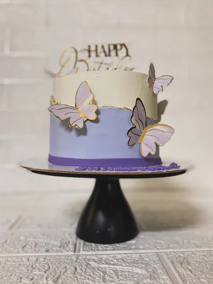 The elegant profile of our butterfly cake on a stand.