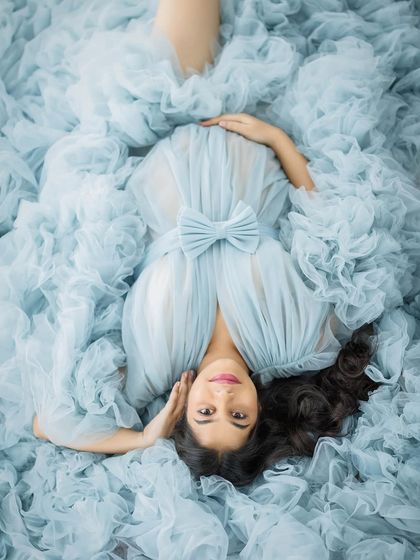 An overhead view capturing the stunning volume of this blue ruffled gown, creating a unique and artistic perspective.