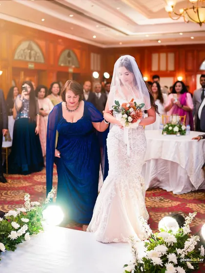 A classic and emotional moment as the bride walks down the aisle in a beautiful Christian wedding ceremony. We are experienced in capturing the traditions and solemnity of diverse cultural weddings.