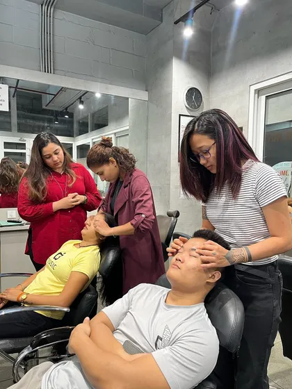 Our students practicing head massages during a hair spa training session. This is an essential skill for providing a complete and relaxing salon experience.