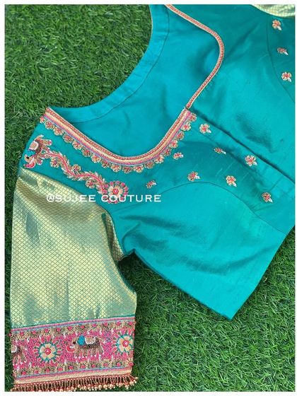 A different view of the teal peacock blouse, showing the simple square neckline and how the embroidery is placed on the front and sleeves.