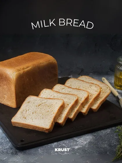 A loaf of our soft Milk Bread, sliced to show its fluffy, even texture. It's perfect for sandwiches or toast, and a favourite for the whole family.