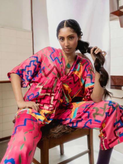 We focused on the details for this shot, highlighting the tie-front blouse and intricate braided hairstyle. The combination of the bold print and the soft styling creates a beautiful balance, perfect for a fashion editorial.