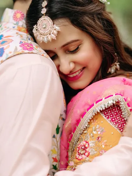 A tender embrace during a vibrant Haldi ceremony. We focus on capturing the genuine emotions and rich colors that make pre-wedding rituals so special and memorable.
