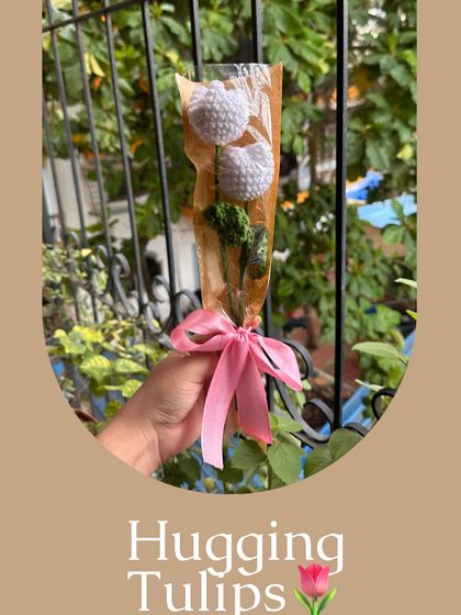 Introducing my "Hugging Tulips," a simple yet sweet arrangement of two white crochet tulips. They are wrapped neatly with a pink ribbon, making them an adorable and thoughtful gift for someone special.