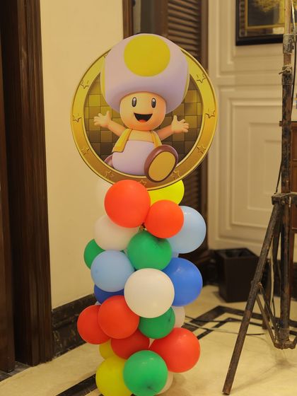 A Toad character cutout on a vibrant balloon pillar. The bright primary colors are perfect for capturing the energetic and playful spirit of the Super Mario universe.