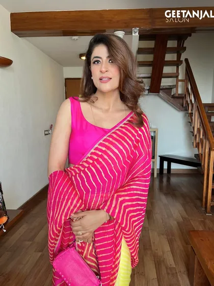 The radiant Tahira Kashyap styled by our team in Jaipur. Her vibrant look features a pop of color on the lips and soft, face-framing hair, showcasing her inspiring spirit.