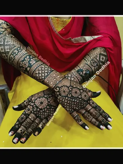 The back of the hands from a full bridal mehendi session. The intricate patterns extend all the way up the arms, ensuring a complete bridal look.