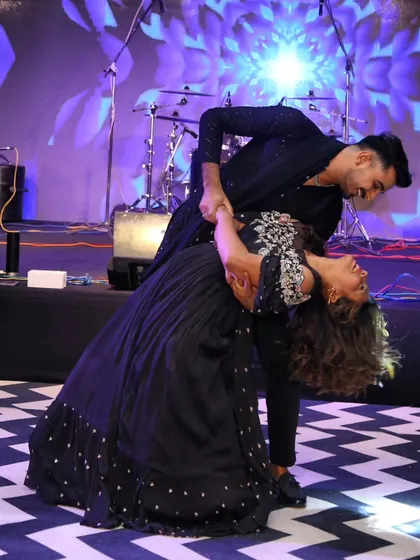 This is the kind of magical moment we love to create. A perfect dip on stage captures the romance and joy of a couple's first dance. We focus on creating beautiful poses like this that make your wedding photos and memories unforgettable.
