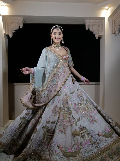 A royal bridal look featuring a Pichwai-inspired lehenga. The intricate cultural artwork on the fabric tells a story, making it a true heirloom piece.