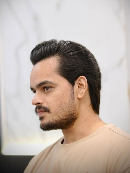 This is the modern wolf cut. It's a heavily layered style that creates tons of texture and movement, perfect for guys who want an edgy, untamed look.