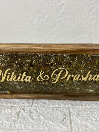 Another view of the wooden frame nameplate, showing the hooks for hanging. It's a practical and beautiful piece of home decor.