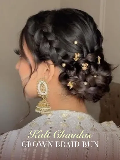 A crown braid bun is a beautiful and traditional choice for Kali Chaudas. This intricate updo keeps hair neatly off the face and looks stunning with traditional Indian earrings.