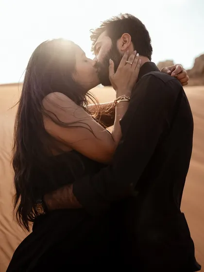 Capturing a kiss in the Dubai desert as the sun sets. We use natural light to create a warm, golden-hour glow, making these intimate moments feel even more magical and timeless.