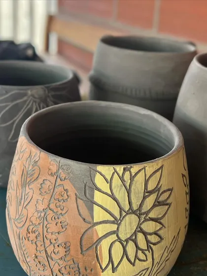 More beautiful work from my students, with intricate carvings and colorful underglaze painting.