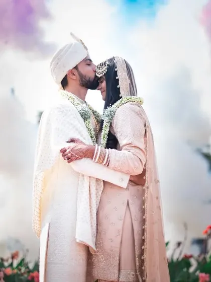 A cinematic finale to the wedding day. Using creative elements like colored smoke adds a touch of magic and creates a truly unforgettable portrait for the couple.