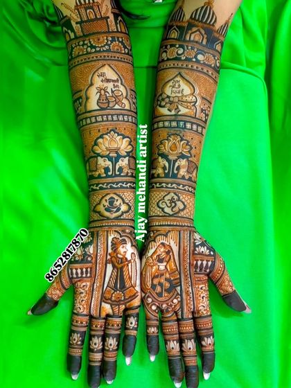 A unique bridal design featuring portraits of the couple on the palms, with their wedding date and names incorporated into the artwork on the forearms.