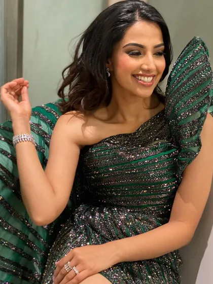 A candid, happy moment from an awards night. This shot in the green sequin gown captures the excitement of the event, showing a real "titli" or butterfly moment.