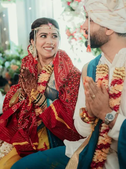 A candid moment from a Maharashtrian wedding ceremony, with the bride looking radiant.