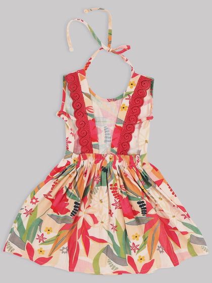 A close-up of the beautiful details on our floral halter dress. The red lace trim adds a lovely pop of color against the tropical print.