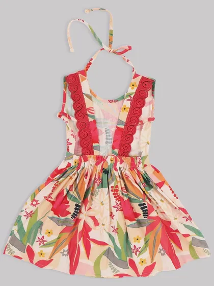 A close-up of the beautiful details on our floral halter dress. The red lace trim adds a lovely pop of color against the tropical print.