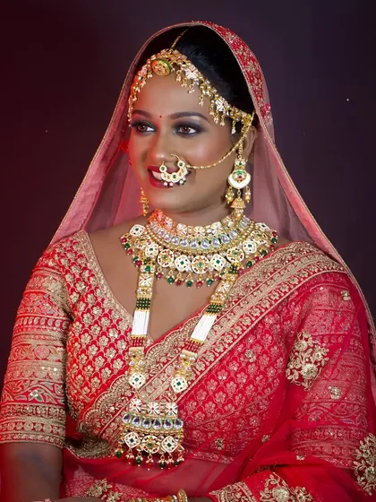 A smiling portrait of the North Indian bride, showing how the makeup glows under professional lighting.