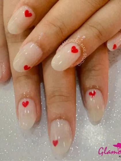 Wear your heart on your nails. This super cute and simple design features a sheer, milky white base with a tiny, perfectly-painted red heart on each nail. It's a minimalist look fatores a lot of love.