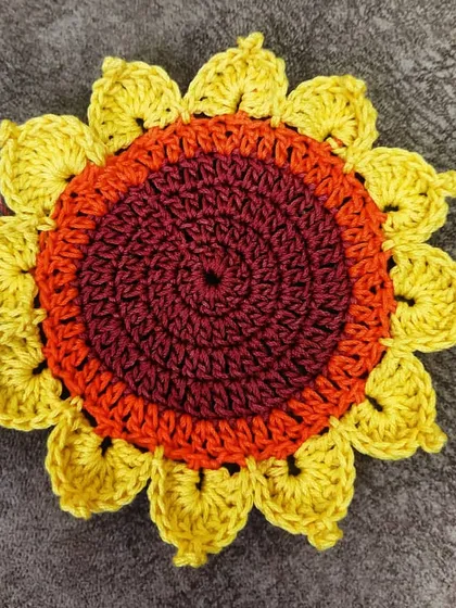 A close-up of a single, beautifully detailed sunflower coaster. The layered petals and rich colors make this a small piece of functional art for your home.