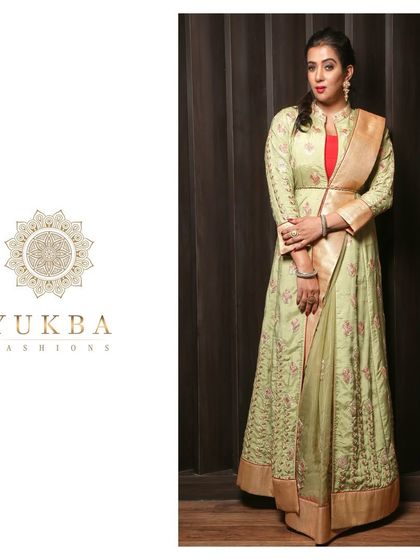 Another pose in the pistachio green gown, emphasizing its sophisticated and modern design.