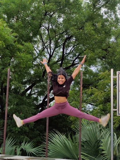 A star jump in the park. Plyometric exercises like this are a fun way to build explosive power and cardiovascular endurance.