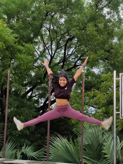 A star jump in the park. Plyometric exercises like this are a fun way to build explosive power and cardiovascular endurance.