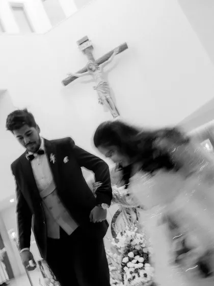 An artistic, motion-blur shot of the couple leaving the church. This black and white image conveys the emotion and movement of the moment, a creative take on a traditional exit.