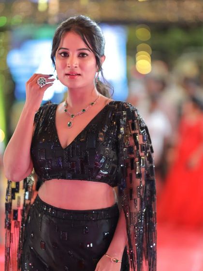 Anusha Rai striking a pose that showcases her statement ring and the unique design of her outfit.