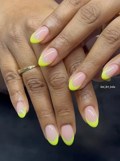 A pop of color for your fingertips. This classic French manicure gets a vibrant update with neon yellow tips, perfect for summer or anytime you want to make a statement.