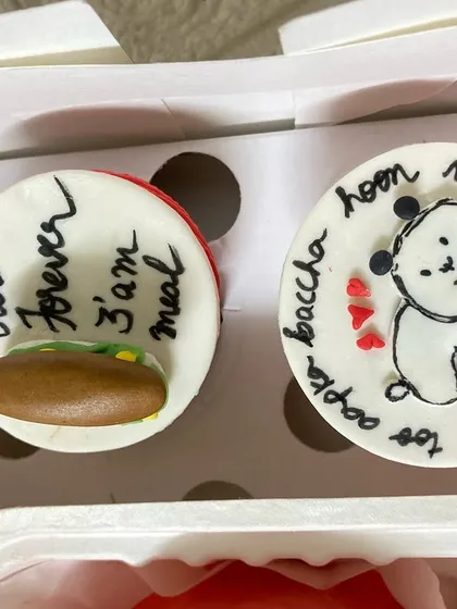 A closer look at the custom cupcakes from a romantic gift set. We can hand-pipe your special messages or create cute illustrations that represent your unique relationship.