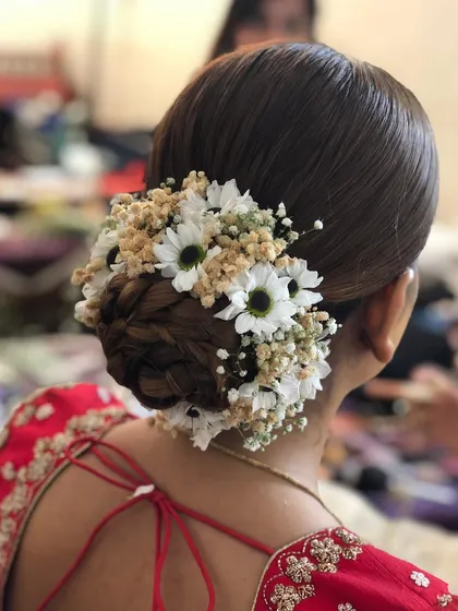 Another angle of the braided floral bun, showing the texture and dimension of the hairstyle. It's a beautiful choice for a bride who wants a unique twist on a classic updo.