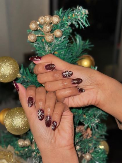 This client is ready for Christmas with her beautiful snowflake-adorned nails.