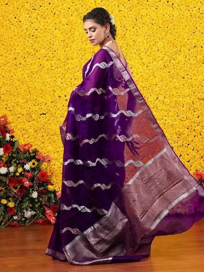 The back view of the purple and silver saree, showing the beautiful sheen of the fabric.