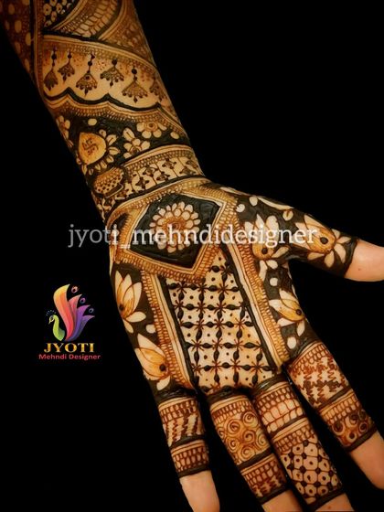 An example of a full-hand Indian mehndi design with a focus on bold, dark shading. This technique makes the floral and paisley elements stand out dramatically.